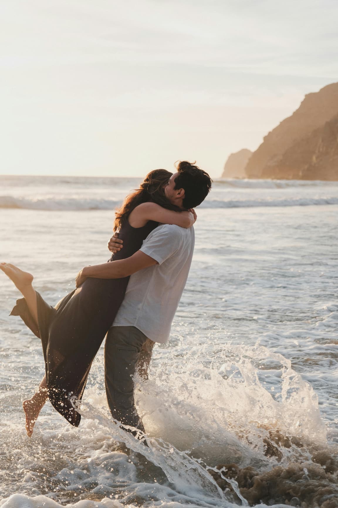 a young couple hugging each other in the benidorm beach with a really romantic atmosphere