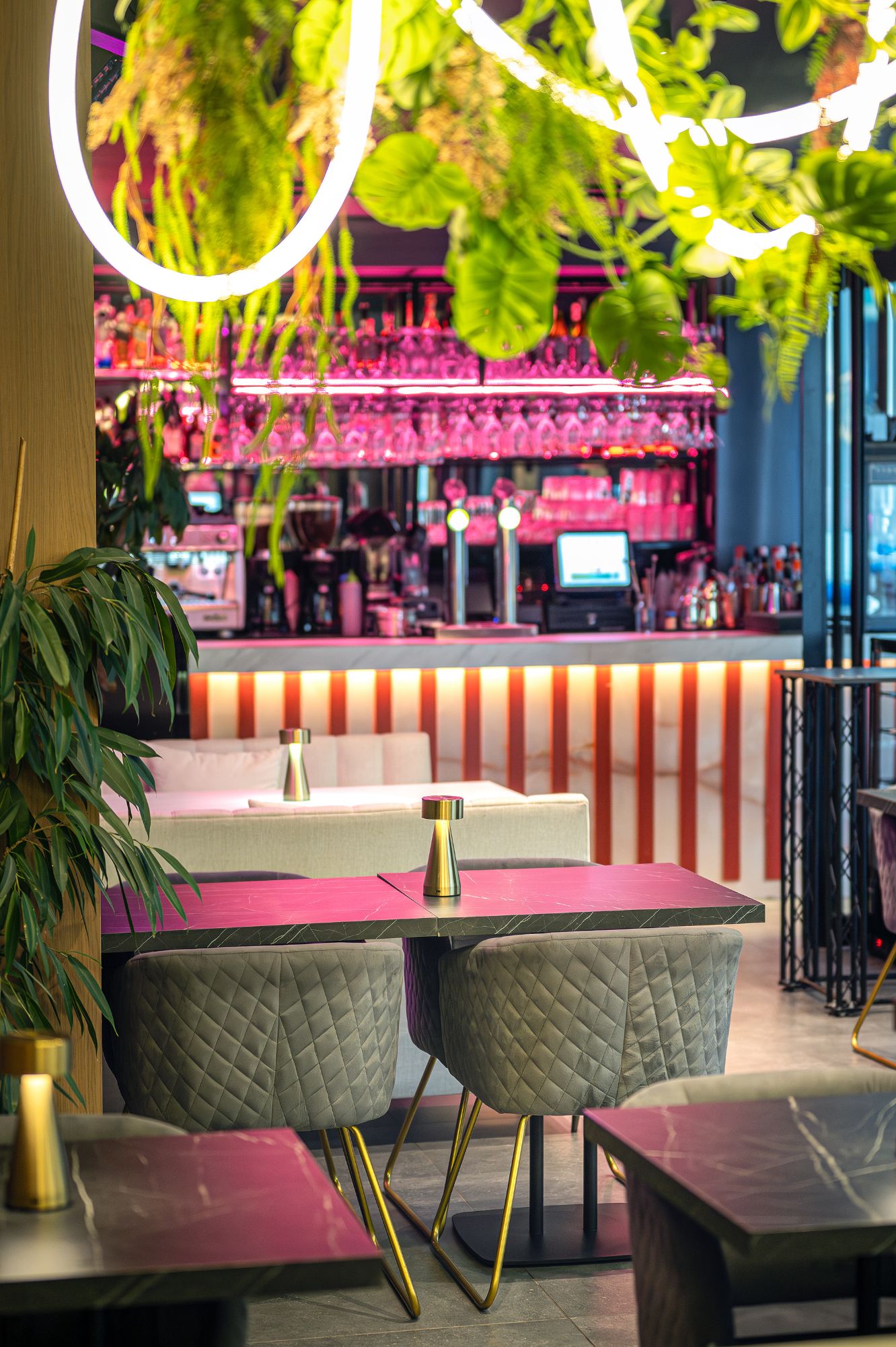 Interior of Baldo restaurant featuring tables and chairs arranged in front of a stylish cocktail bar.