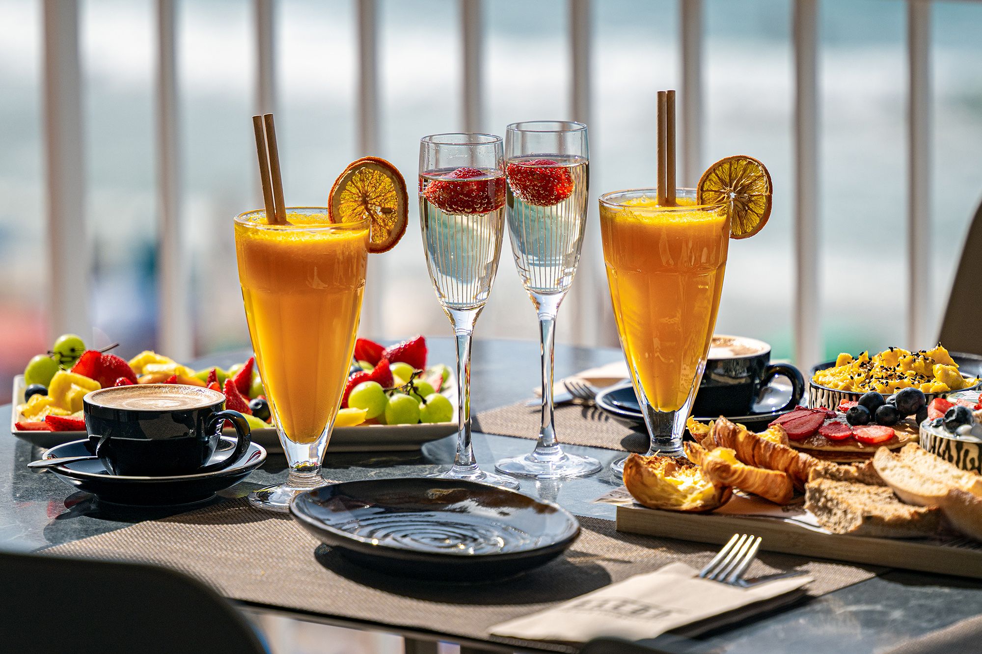 A table brimming with appetizing food and drinks, showcasing a delightful spread ready for a gathering or celebration.