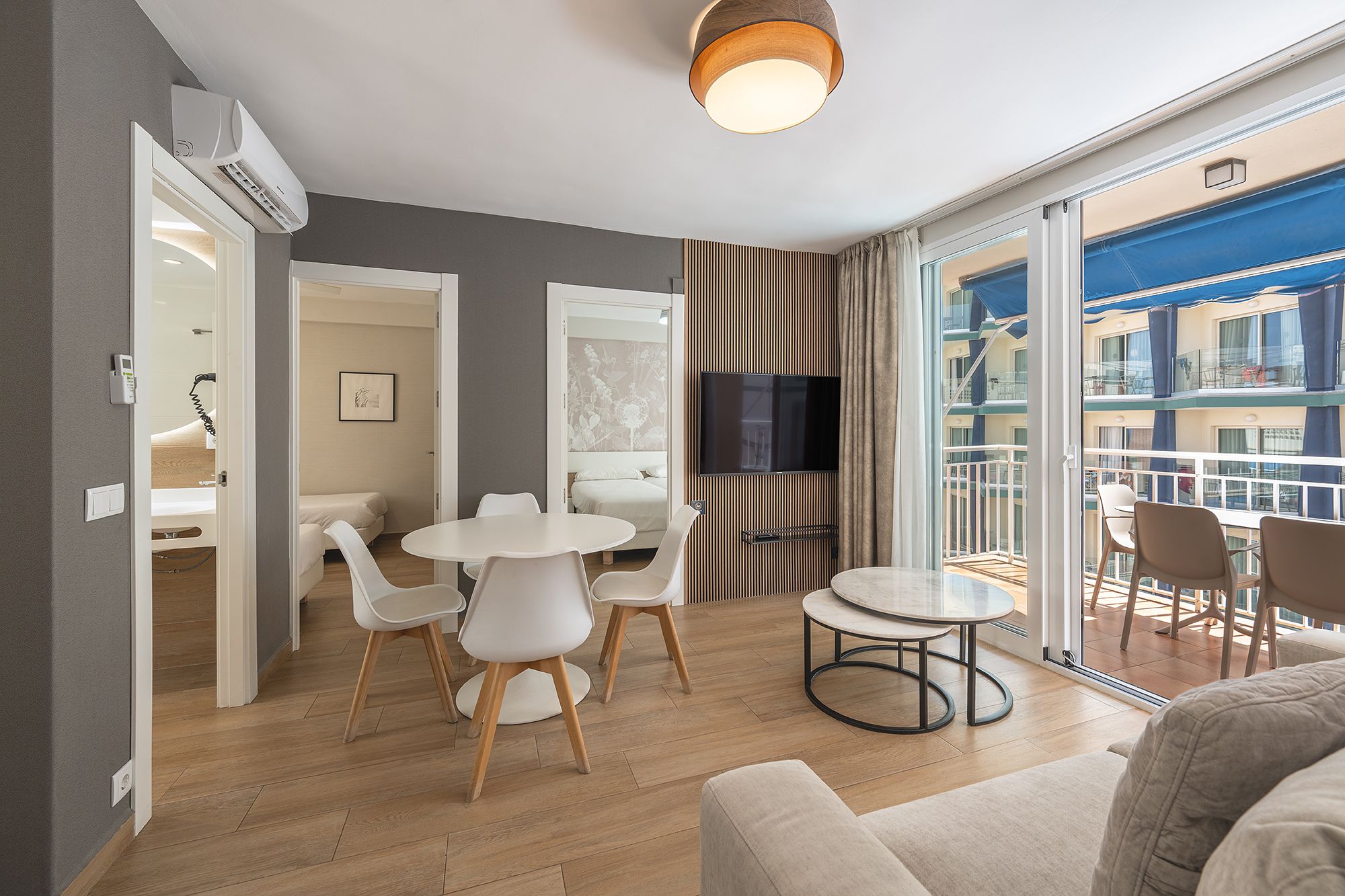 A bright living room with a dining table and chairs, perfect for meals and socializing with family and friends.