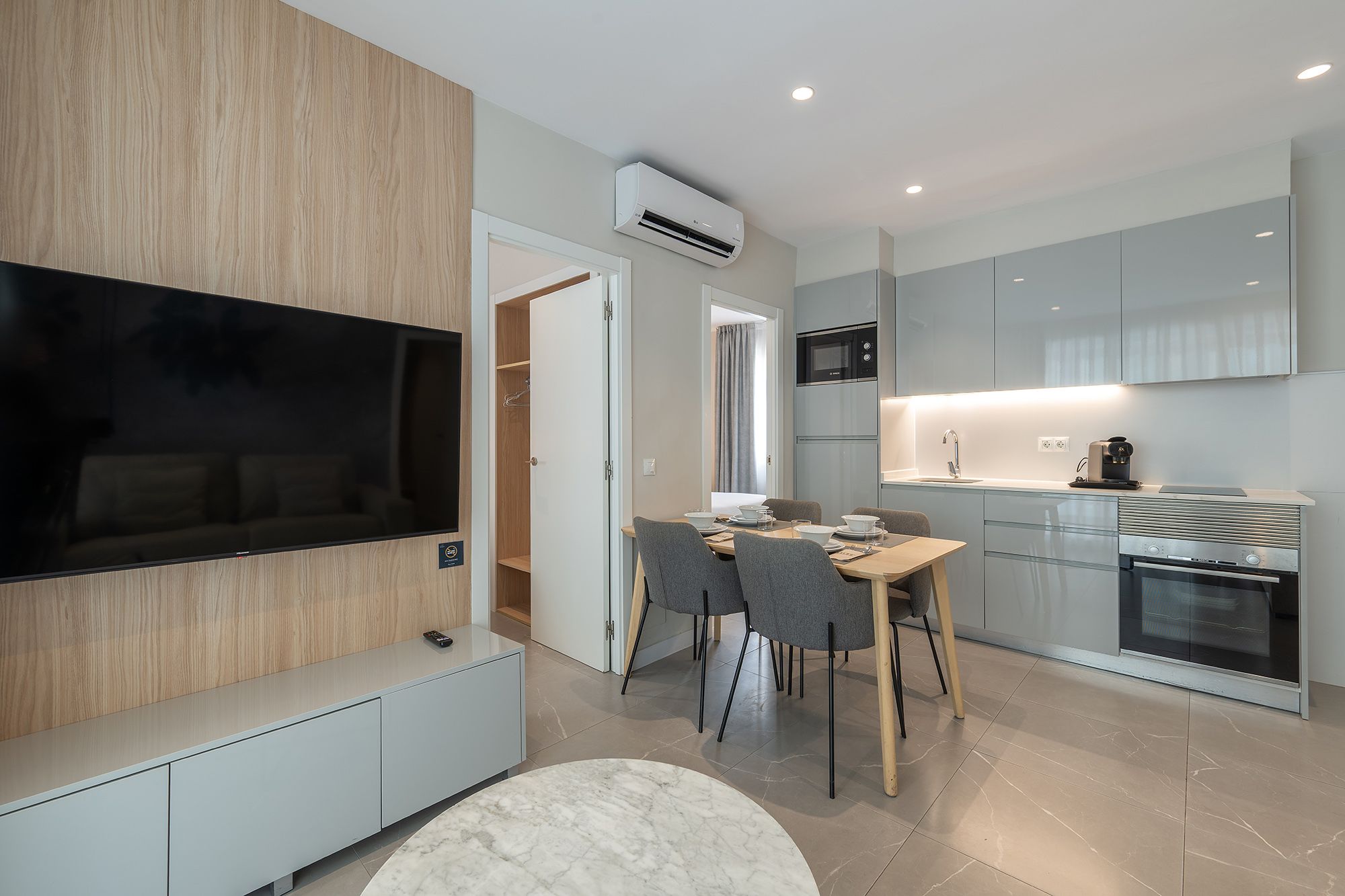 A modern apartment featuring a sleek kitchen, cozy living room, and stylish dining area.