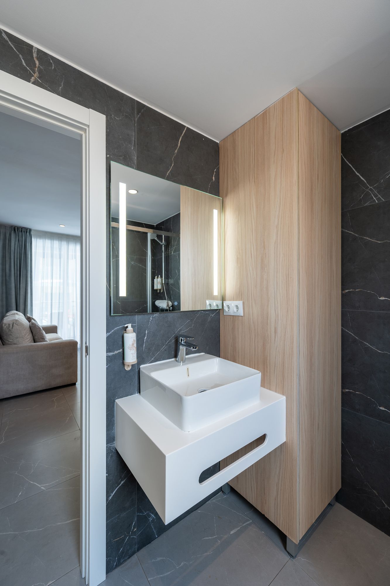 A minimalist bathroom scene with a contemporary sink and a mirror, highlighting simplicity and elegance.