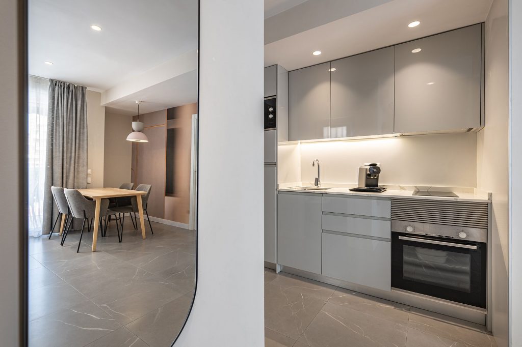 Bright and airy kitchen-dining area with modern design elements in a contemporary apartment setting.