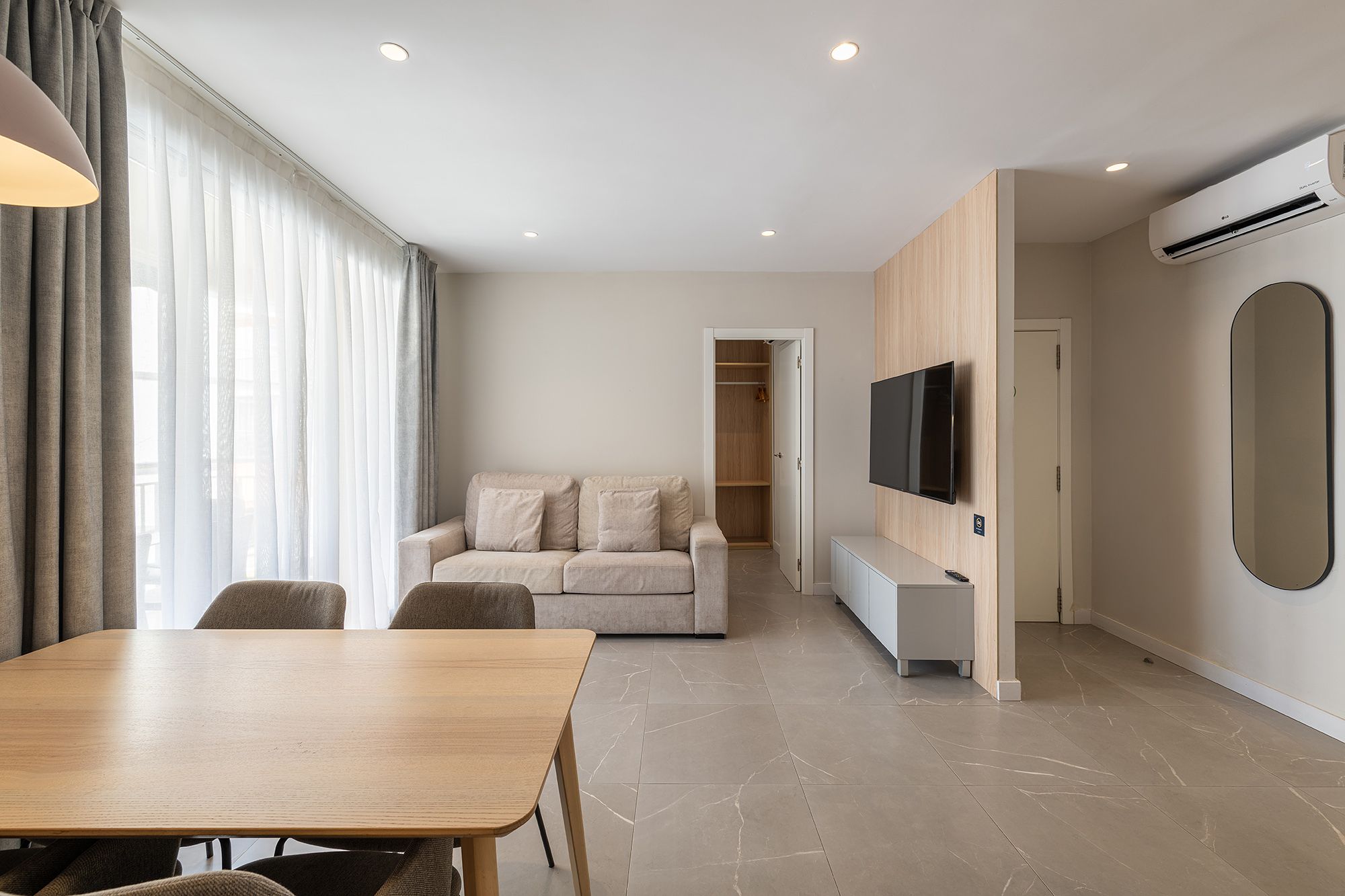 Bright modern apartment with an open kitchen and a welcoming dining area.