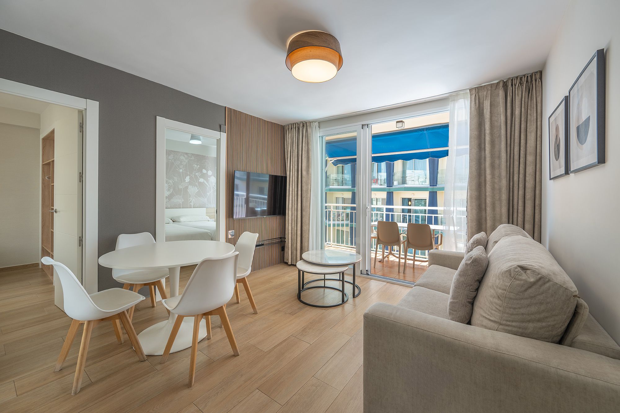 A contemporary aparthotel interior showcasing a chic dining table with matching chairs, perfect for gatherings.