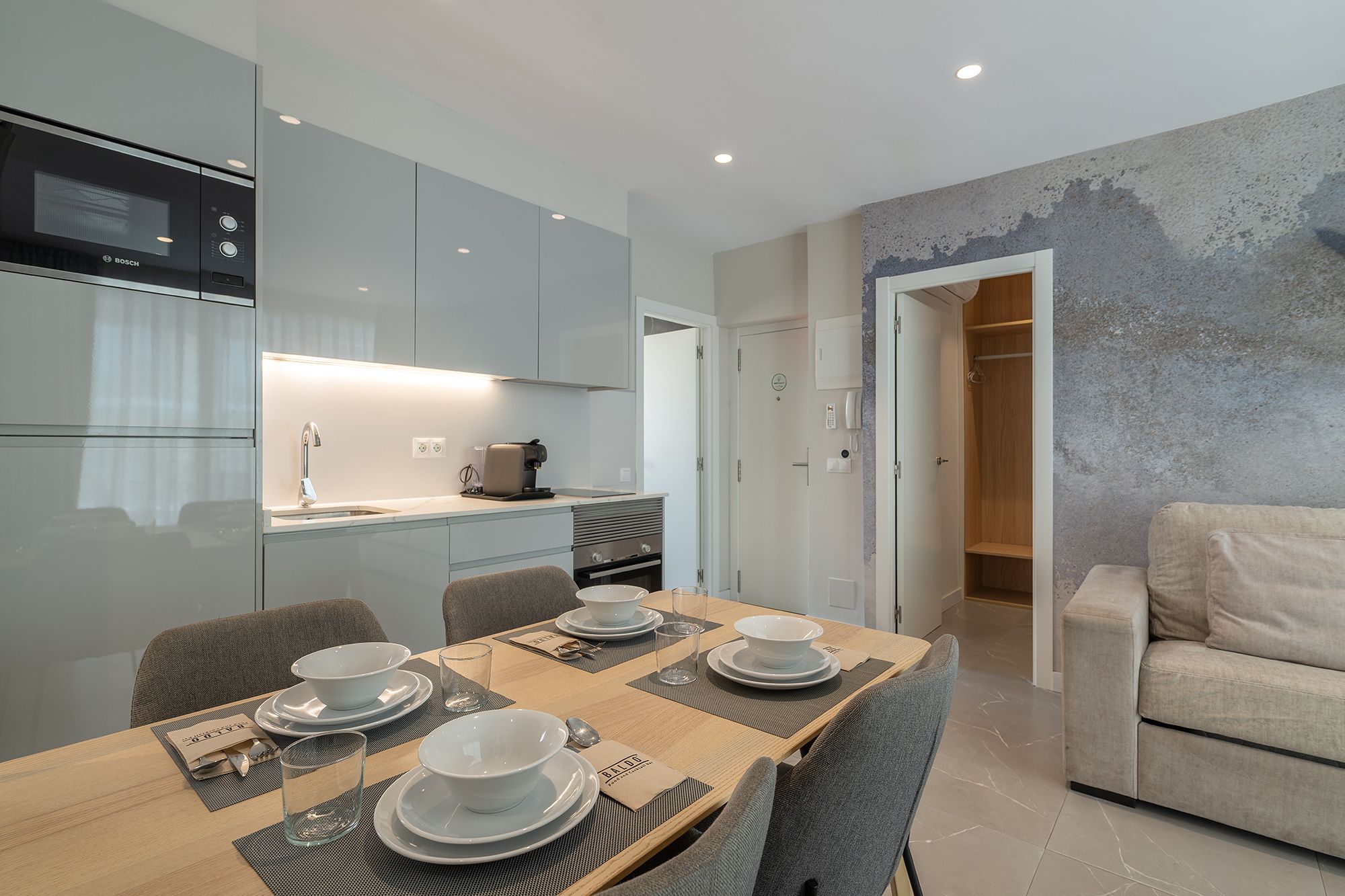 Stylish kitchen and dining area in a modern apartment, showcasing delicious dishes from Baldo Restaurant, Benidorm.