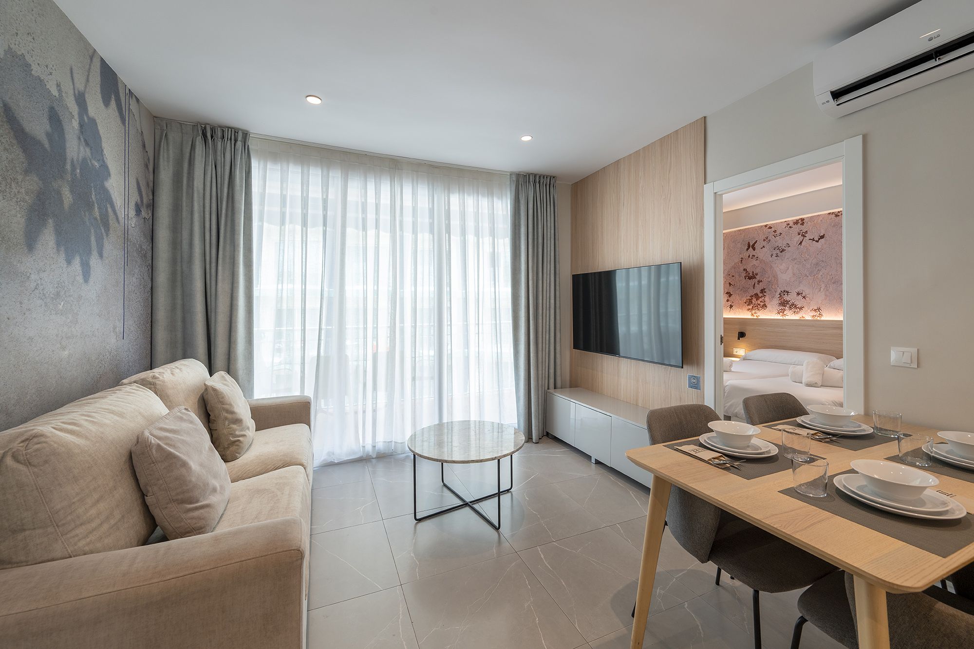 Stylish apartment interior with a dining table and a couch, highlighting a modern aesthetic.