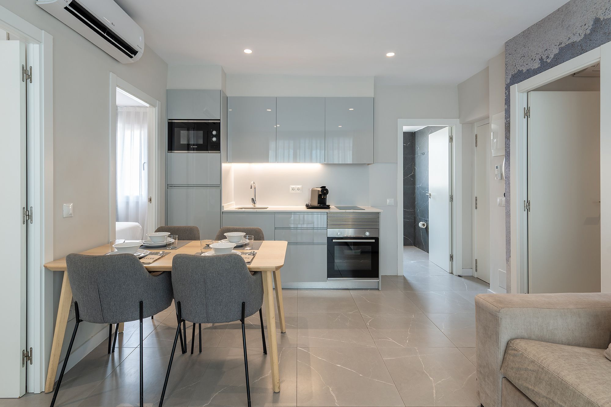 A compact, contemporary kitchen and dining space showcasing minimalist design and inviting decor for casual meals.