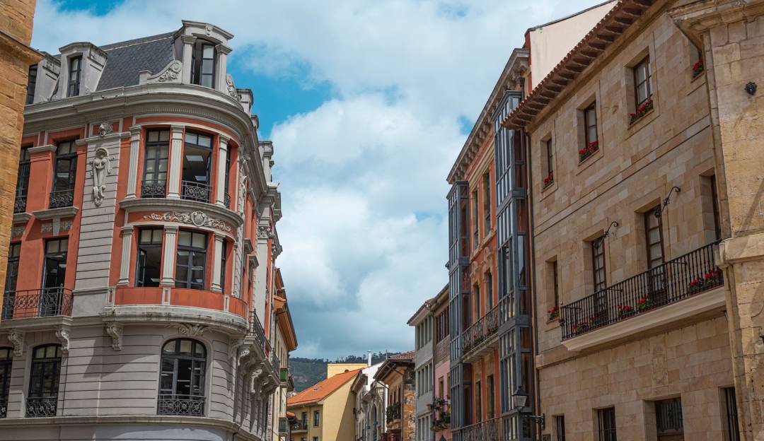 A sunny street in old town Benidorm, Spain, lined with charming buildings under a clear blue sky.