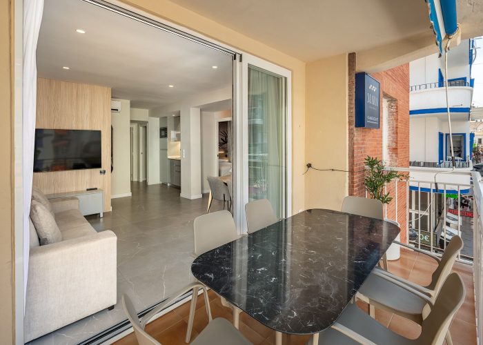 Interior view of a touristic apartment in Benidorm, Spain, showcasing modern furnishings and bright decor.