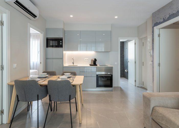 A compact, contemporary kitchen and dining space showcasing minimalist design and inviting decor for casual meals.