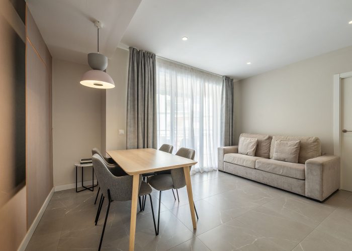 Contemporary apartment interior showcasing a dining area with a table and chairs.