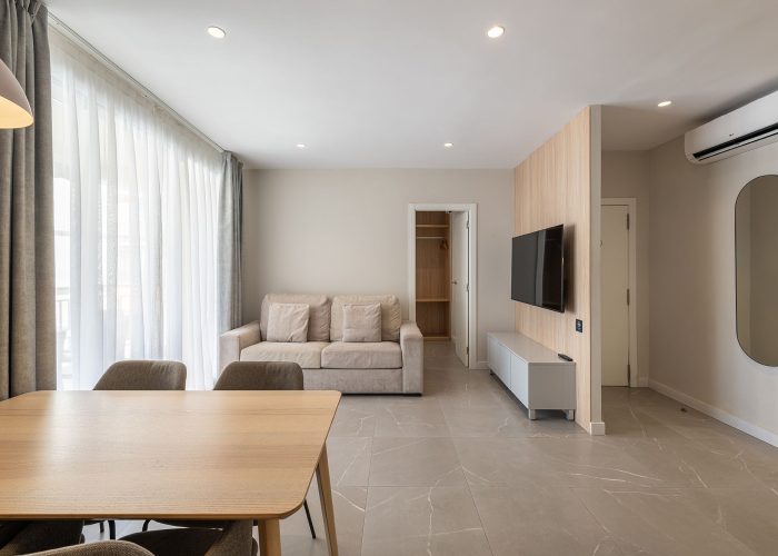 Bright modern apartment with an open kitchen and a welcoming dining area.