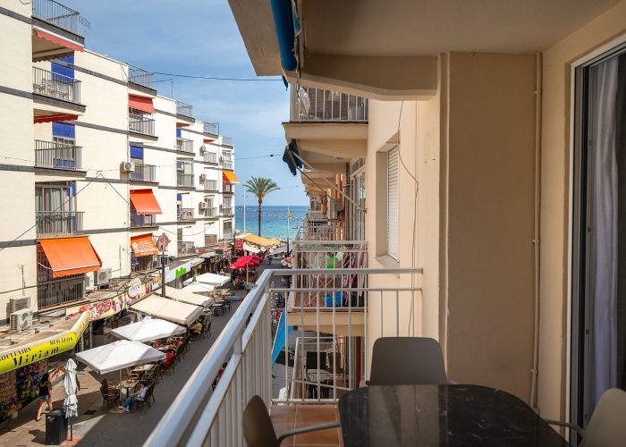 Self catering apartment in Benidorm, Spain, featuring modern design and scenic views of a vibrant street near the sea