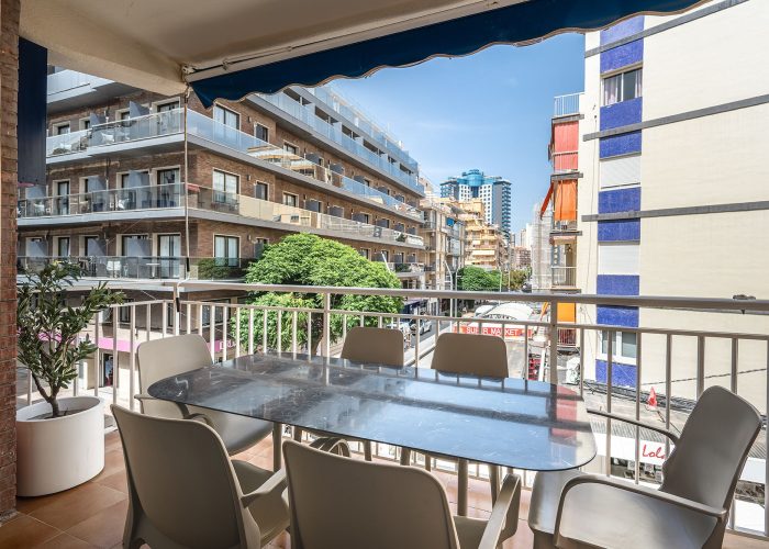Beachside apartment in Spain featuring a terrace balcony with a view of Benidorm's coastline